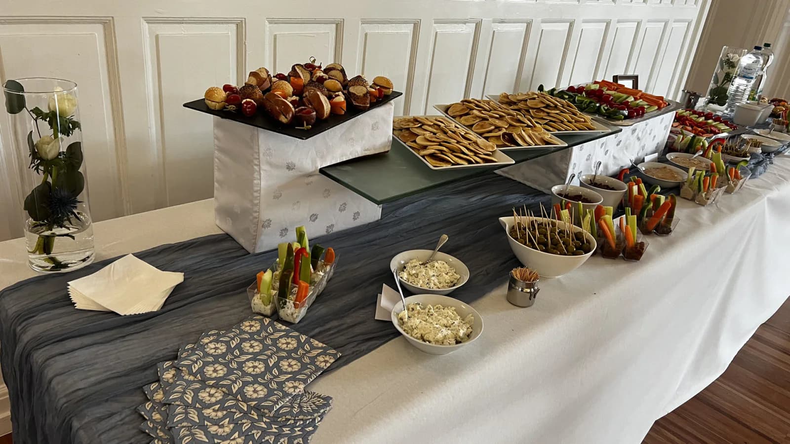 Buffet apéritif dressé avec petits pains, légumes frais, sauces et bouchées salées